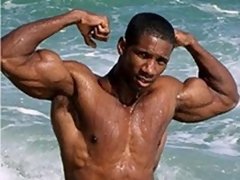 Hunk dude with nice muscular body is dancing around outdoor